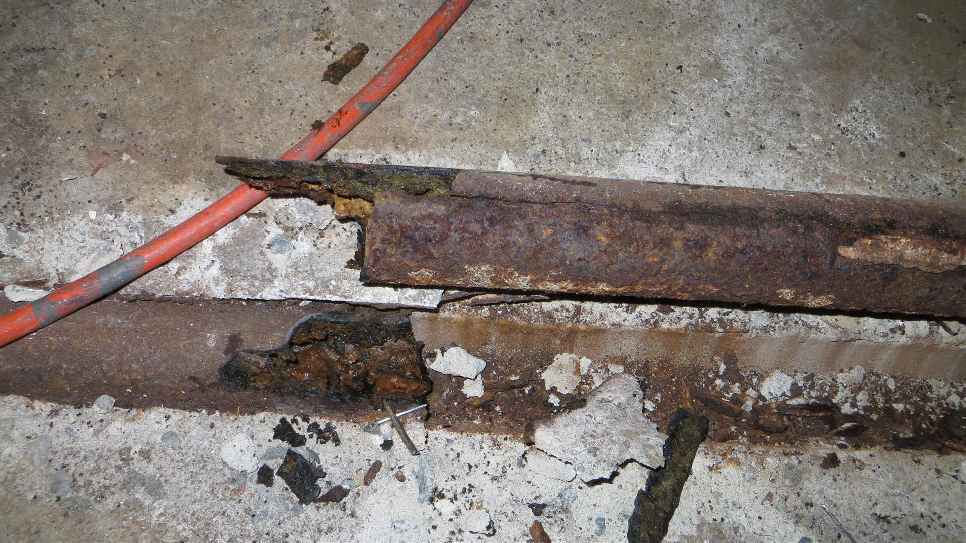 This cast iron horizontal waste pipe was fractured, rusted, and 2/3 plugged.