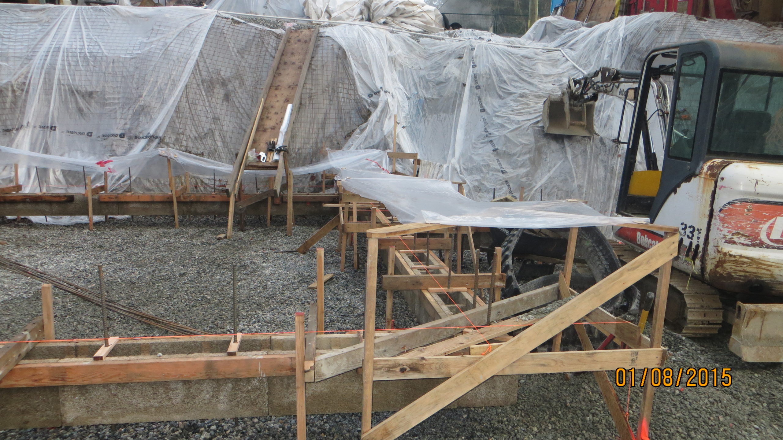 Covering footings with plastic to allow ICF blocks to dry out and then protect from rain after pour