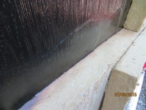 To apply the ROCKWOOL, I heat the surface of the membrane with a torch and then just press insulation to membrane. For bottom row I also heated just above the transition so some of the bitumen would flow down onto the top surface of the ROCKWOOL.