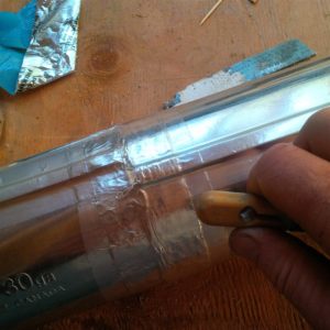 Step 1 - Apply high quality HVAC Foil tap to all seams.  I used the back end of a plastic brush handle to flatten out the tape and ensure well adhered.  Notice also the the lengthwise seams to the left and right of the joint have been sealed.