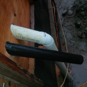 Here is the business end.  The black ABS will transition back to PVC before gravity feeding to a shallow storm sump by the District connection.  The white PVC pipe connected down to the perimeter drainage 12' below and will provide a clean-out port.