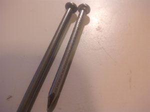 See common nail on left and official hanger nail on right